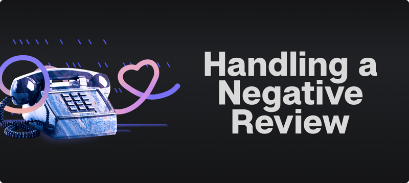 Push-button desk phone with a heart-shaped line beside the title Handling a Negative Review